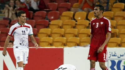 Andranik Teymourian, centre, kneels on the field as he celebrates Iran’s victory over the UAE. Edgar Su/Reuters