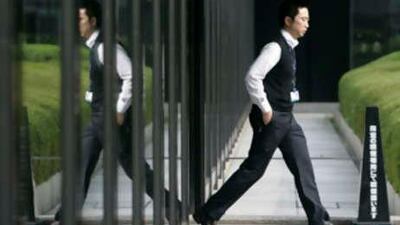 A businessman walks out of a building in Tokyo on Nov 17 2008. Japan slid into its first recession in seven years in the third quarter as the financial crisis curbed demand for Japanese exports.