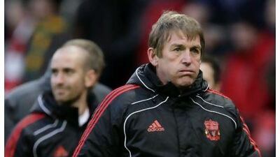 Kenny Dalglish, right, leaves the field after losing to Manchester United in their English FA Cup match on Sunday. Jon Super / AP Photo