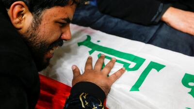 A man mourns near the coffin of a man, who was killed in a twin suicide bombing attack in a central Baghdad market, during a funeral in Najaf, Iraq. REUTERS