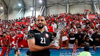 Bahrain'goalkeeper Sayed Jaffer poses with the trophy. AFP