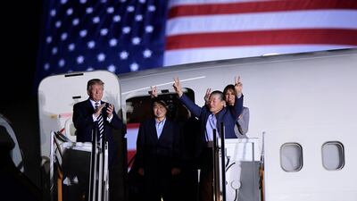 President Donald Trump, from left, greets Tony Kim, Kim Hak Song, seen in the shadow, and Kim Dong Chul, three Americans detained in North Korea for more than a year, as they arrive at Andrews Air Force Base. Susan Walsh / AP Photo