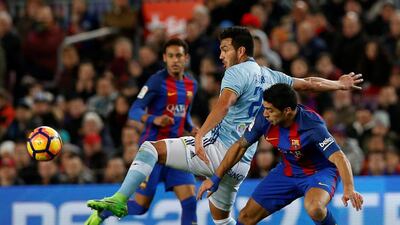 Barcelona’s Luis Suarez and Celta Vigo’s Gustavo Cabral in action. Albert Gea / Reuters