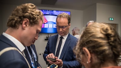 Sylvain Maillard, MP for President Macron's En Marche party, and supporters check poll results during the second round of the French parliamentary elections in Paris. EPA