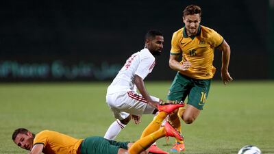 Abdelaziz Mohammed Sanqour of the UAE tackles the ball off Matthew Leckie of Australia durng the international friendly between the UAE and Australia at Mohamed Bin Zayed Stadium on October 10, 2014 in Abu Dhabi, United Arab Emirates. Warren Little/Getty Images