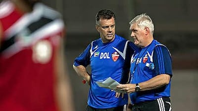David O'Leary, centre, the Al Ahli coach, talks to his assistant Roy Aitken as they run the rule over their charges during a training session this week.