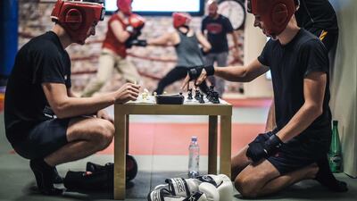 Chessboxers play a round of chess during a chessboxing training in Paris, on September 22, 2019. AFP