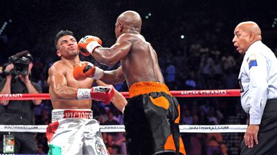WBC Welterweight champion Victor Ortiz, left, falls towards the canvas after being hit with a right from Floyd Mayweather in the 4th ending the fight. Mayweather controversially knocked out Ortiz to win the WBC Welterweight title, while Ortiz was apologi???