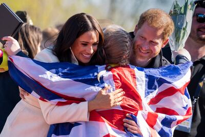 Prince Harry and Meghan Markle hug a competitor at the Invictus Games in The Hague. AP Photo