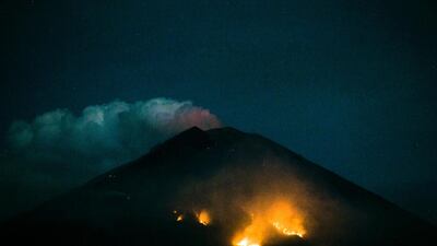 A Forest fire is seen on the slope of Mount Agung volcano after an eruption, as seen from Amed Village in Karangasem, Bali, Indonesia. Made Nagi / EPA