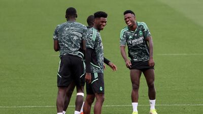 Real Madrid defender Aurelien Tchouameni and forward Vinicius Junior enjoy a joke at training. AFP