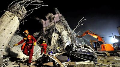 Rescuers remove debris as they continue to search for survivors from a collapsed building following a 6.4 magnitude earthquake that struck the area in Tainan, south Taiwan. Ritchie B Tongo / EPA