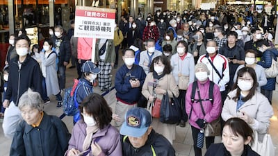 People wearing protective face masks queue as they try to watch the Olympic cauldron during the Tokyo 2020 Olympics Flame of Recovery tour at Sendai Station, Miyagi prefecture, on Saturday. Kyodo/Reuters