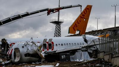 Workers remove the wreckage after investigators has finished their work at the Pegasus Airlines plane that skidded Wednesday off the runway at Istanbul's Sabiha Gokcen Airport, in Istanbul. AP Photo