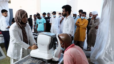 Labourers waiting for their turn for the free eye check-up at the Majlis optical stall at the park in Sharjah.