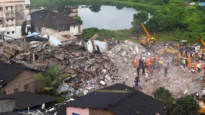 A rescue worker searches for people in the rubble of a collapsed five-storey apartment building in Mahad, about 170 kilometres from India's financial capital of Mumbai. AFP