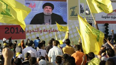 People listen to Hezbollah chief Hassan Nasrallah as he speaks via a giant screen during the celebration in the southern town of Bint Jbeil, Lebanon. EPA