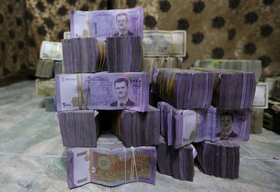 Stacks of Syrian pounds in a currency exchange shop in the city of Azaz, near Aleppo. Reuters