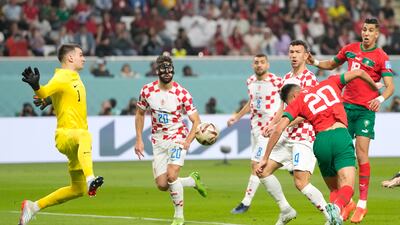 Morocco's Achraf Dari scores with a header. AP