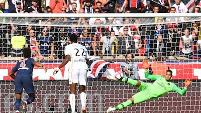 PSG's goalkeeper Alphonse Areola, right, concedes a penalty. AFP