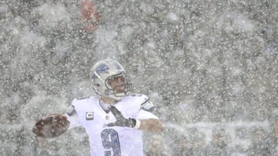 Detroit Lions quarterback Matthew Stafford attempts to throw through the snowfall. The Eagles and Lions struggled in the conditions at first but eventually Philadelphia won, 34-20. Matt Rourke / AP