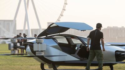 Guests check out the X2 flying car at Skydive Dubai on Monday evening. The vehicle has a top speed of 130kph.