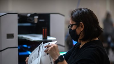 A poll worker tabulates ballots in Maricopa County. Bloomberg