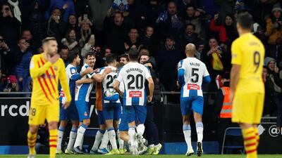 Espanyol's Wu Lei celebrates scoring their second goal with teammates as Barcelona's Jordi Alba and Luis Suarez look dejected. Reuters