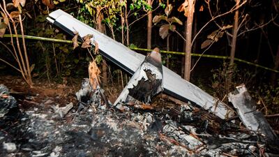 The tail of the burnt fuselage of a small plane that crashed, rests near trees in Guanacaste, Corozalito, Costa Rica on December 31, 2017. Ezequiel Becerra / AFP