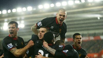 Liverpool players celebrate with Raheem Sterling after he scores their second goal in a Premier League win over Southampton on Sunday at St Mary's Stadium. Richard Heathcote / Getty Images
