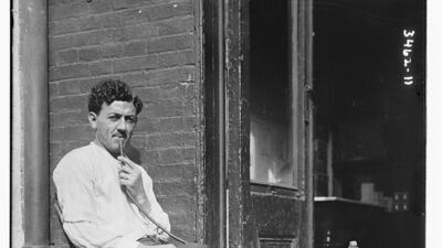 A man smokes a pipe on his porch in Little Syria more than a century ago. Photo: Library of Congress