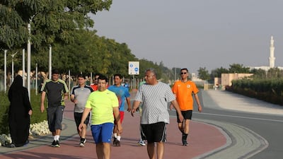 People walking and jogging at the Quran Park in Al Khawaneej area in Dubai last month. Pawan Singh / The National