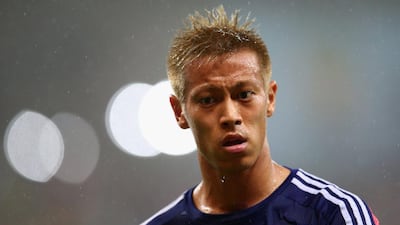 Keisuke Honda of Japan looks on in the rain during his team's match against Ivory Coast at the 2014 World Cup on Sunday. Julian Finney / Getty Images / June 14, 2014