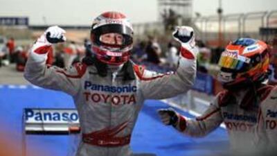 The Toyota driver Jarno Trulli celebrates in the parc ferme after the qualifying session of the Bahrain Formula One Grand Prix at the Sakhir racetrack.