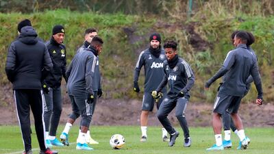 Manchester United players take part in training.