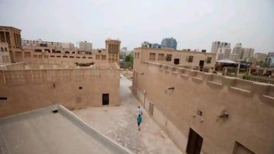 Tourists walk along Dubai's historic Bastakiya area. The majority of buildings, wind towers and residences in Bastakiya comprise of gypsum and stone and are thought to date back to as far as 1890. The historic area is now home so many guest houses, art cafes and galleries. Razan Alzayani / The National