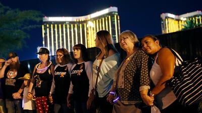 Survivors form a human chain around the shuttered site of the music festival. AP