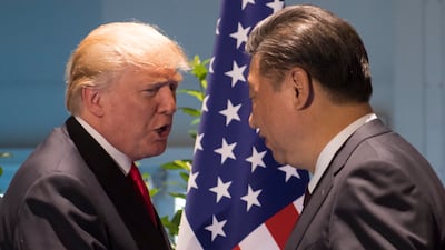 US President Donald Trump and Chinese President Xi Jinping, right, shake hands as they arrive for a meeting on the sidelines of the G20 summit