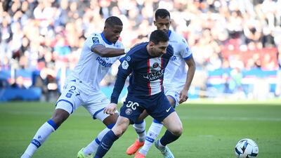 Lionel Messi fights for the ball with Auxerre's Julian Jeanvier. AFP