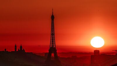 The sun rises over Paris in July, when scientists said 'we continued to witness the effects of a warming world'. AFP