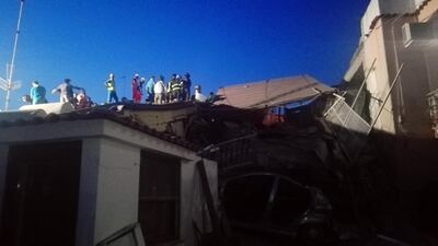 Rescuers work among damaged houses on Ischia Island, Italy. Carabinieri Press Office / EPA