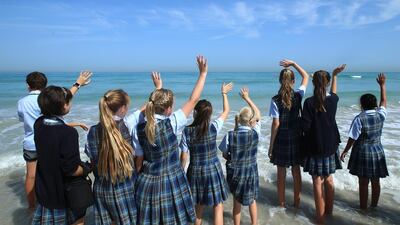 Cranleigh School children wave good bye to the released turtles at Saadiyat beach club in Abu Dhabi. Ravindranath K / The National
