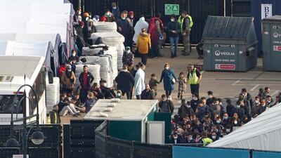 Migrants wait to be processed after arriving in the UK on small boats. PA