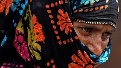 A woman covers her face with cloth a mask in Bangalore. India is seeing a second wave of the virus which has led several states including Maharashtra and the capital, New Delhi, to impose new restrictions. EPA / JAGADEESH NV