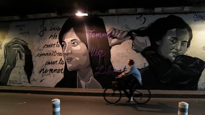 A mural in Paris depicts women cutting their hair to show support for Iranian protesters. AP
