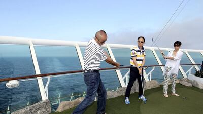 Chinese tourists play mini golf on the cruise ship Mariner of the Seas during her voyage from Shanghai to Jeju in South Korea. AP Photo