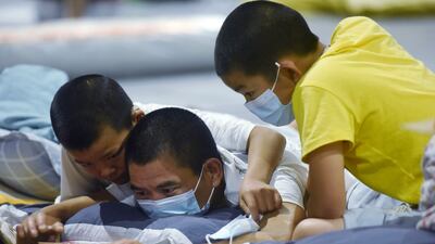 People share a mobile phone in an exhibition hall in Hangzhou in eastern China's Zhejiang province.