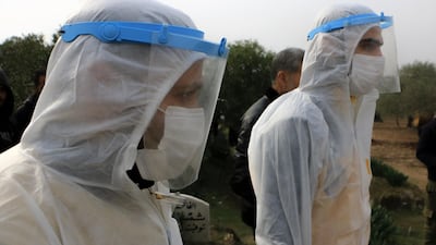 White Helmet members look at the friends and relatives of the victim.