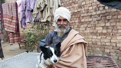 Balbir Singh with his dog Jacky. He plans to return to the farmer protests after collecting fresh clothes.