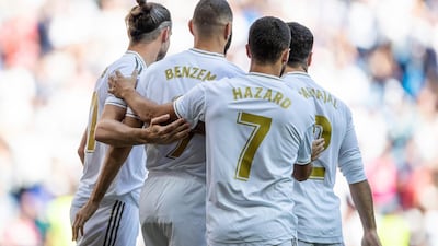 Real Madrid's Karim Benzema, second left, is congratulated by teammates after scoring. AP